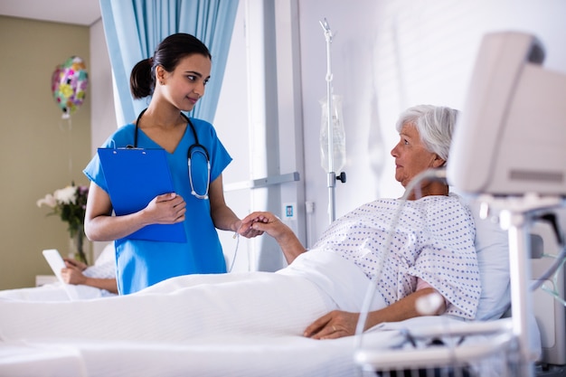 Female doctor examining senior woman