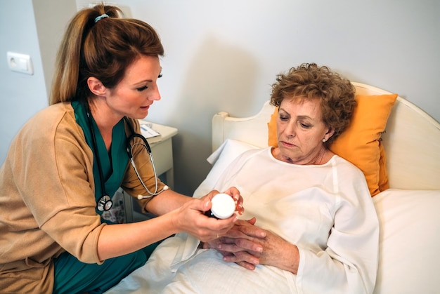 Female doctor explaining posology to a senior patient