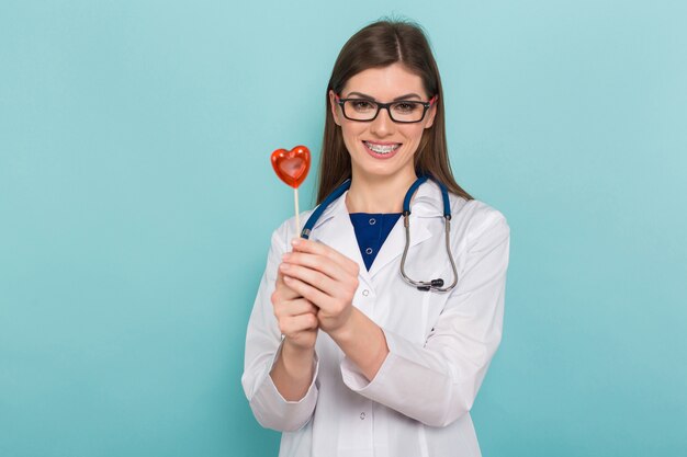 Female doctor in glasses with lollipop