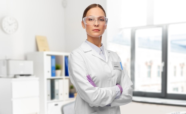 female doctor in goggles and gloves at hospital