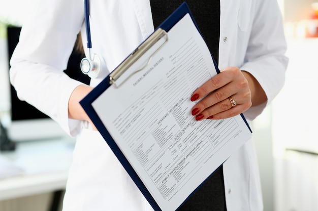 Female doctor hand holding and filling patient