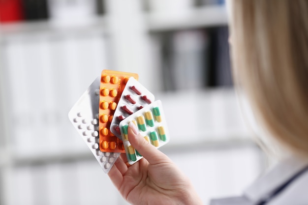 Female doctor hand holding pack of different