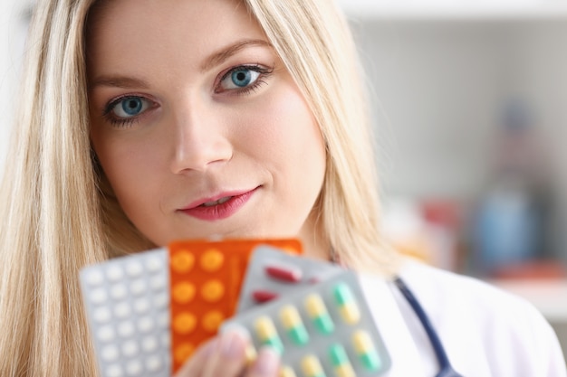 Female doctor hand holding pack of different