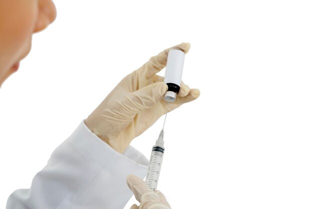 Female doctor hands holding a vial and injection