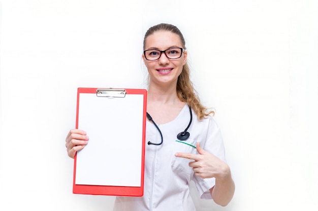 female doctor happily shows her tablet with paper and smiles.