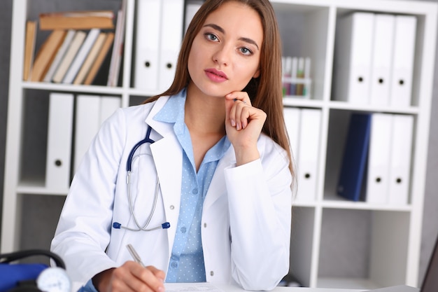 Female doctor hold hold in arm silver pen