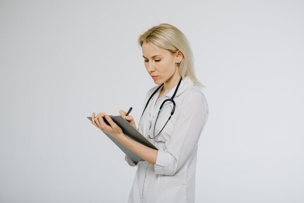 Female doctor holding a clipboard isolated over a white