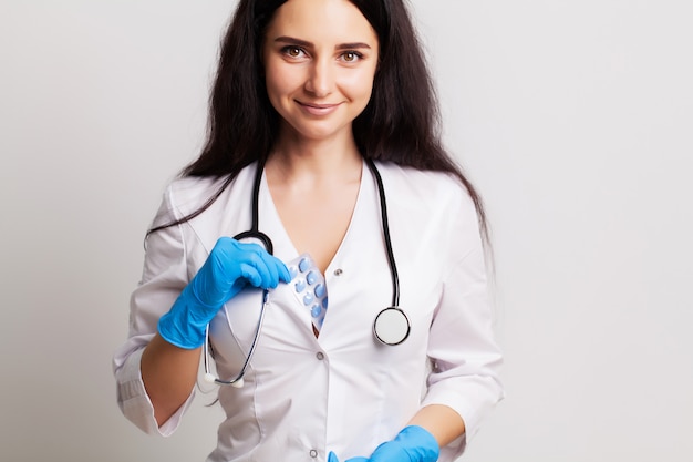 Female doctor holding pills prescribed for patient treatment