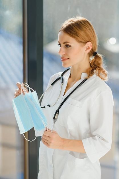 Female doctor holding protective masks