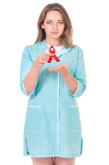 Female doctor holding a red ribbon as a symbol of AIDS