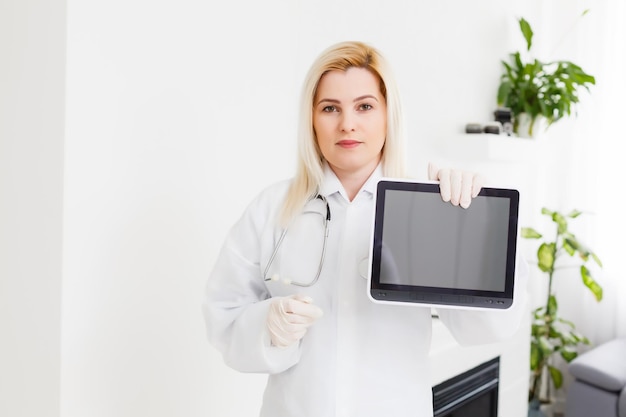 Female Doctor Holding Tablet PC. Doctor's hands close-up. Medical service and health care concept.