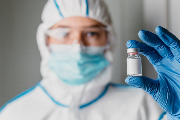 Female doctor holding a vaccine bottle