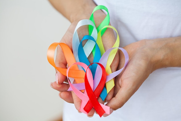 Female doctor holds colored ribbons symbolize awareness of various diseases