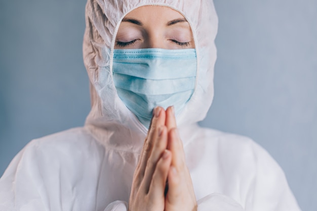 A female doctor is praying. Close up.