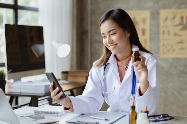 Una dottoressa è in videochiamata con un paziente tramite uno smartphone per fornire consigli sulla consulenza di esperti di malattie e sul trattamento della malattia trattamenti mirati concetti medici e specialisti