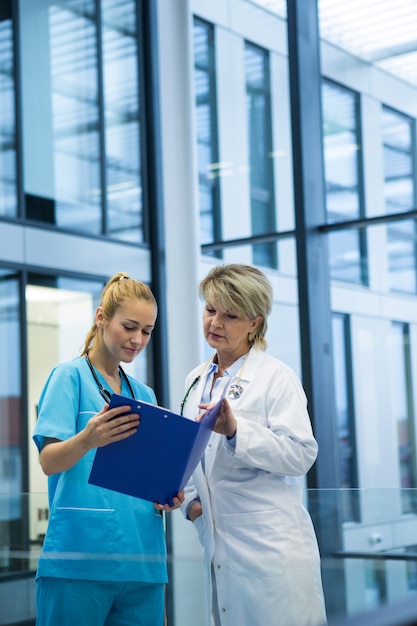 Female doctor and nurse looking at a medical report