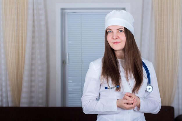 Female doctor or nurse standing with stethoscope medicine concept