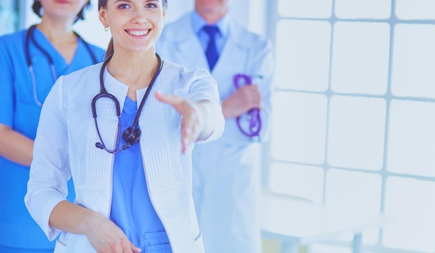 Female doctor offering a handshake in the hospital