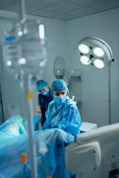 a female doctor performs an operation in a sterile operating room surgical intervention operation doctor in sterile clothes