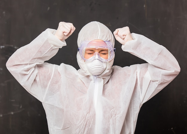 female doctor in protection suit and glasses with mask