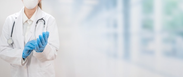 Female doctor in the protective suit and mask looking for a cure for the disease Copy text