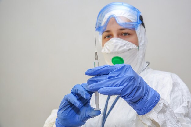 Female doctor in a protective suit