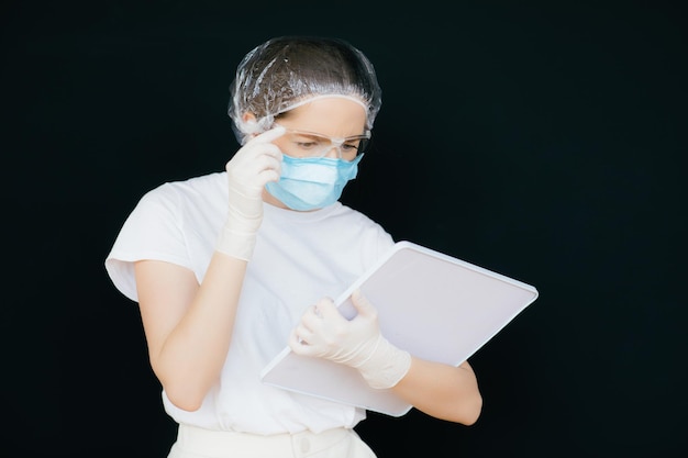 Female doctor in the protective suits and mask