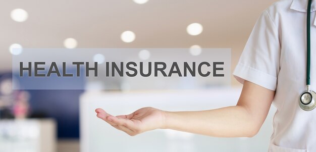 Photo female doctor showing health insurance text with blur hospital room background healthcare concept