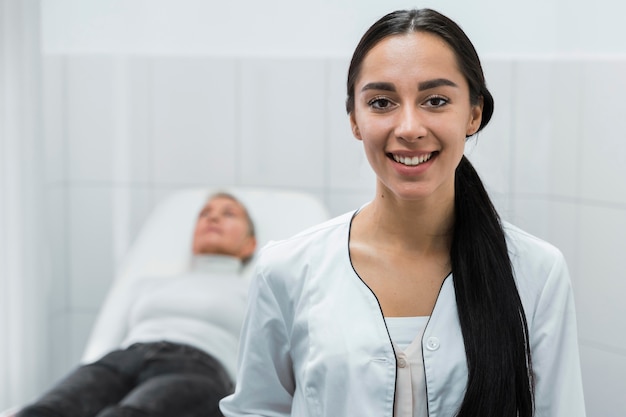 Female doctor smiling next to blurry patient