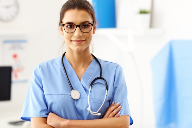 female doctor standing in front of her office