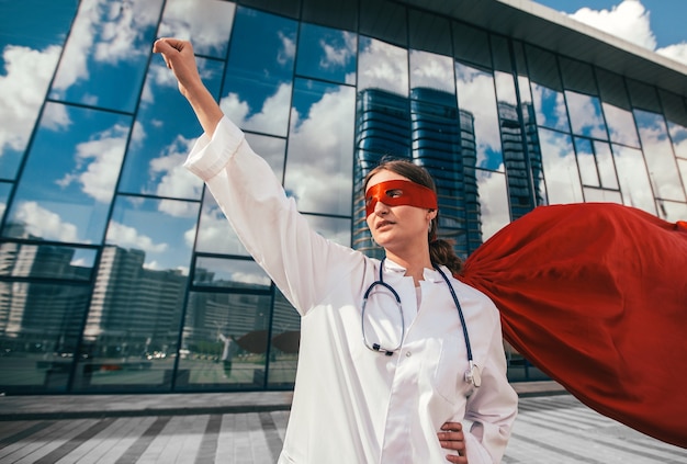 Female doctor in a superhero Cape is ready to help