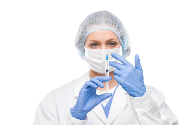 female doctor in surgical gloves moving air bubble from syringe while preparing for injection