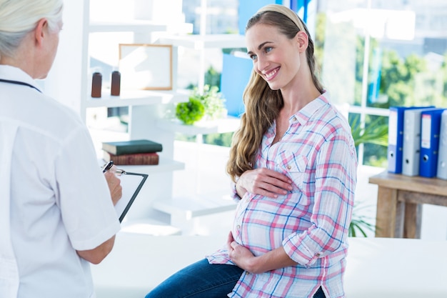 Female doctor talking to a pregnant woman