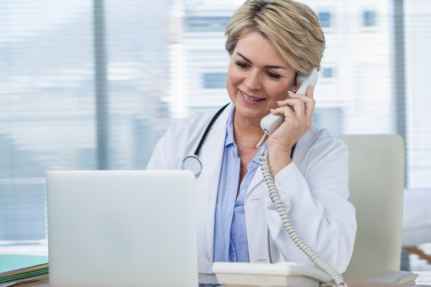 Female doctor talking on telephone