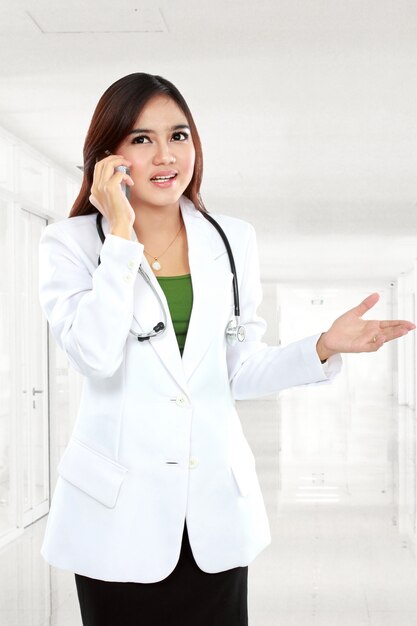 Female doctor talking with cellphone