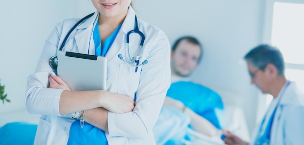 Female doctor using tablet computer in hospital lobby