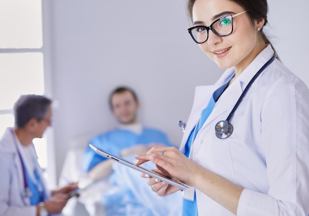 Female doctor using tablet computer in hospital lobby