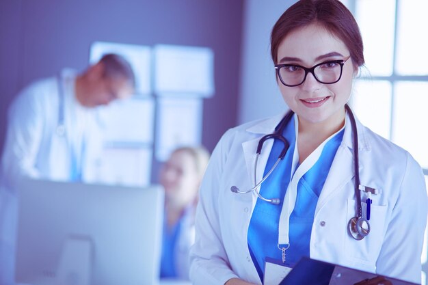 Female doctor using tablet computer in hospital lobby