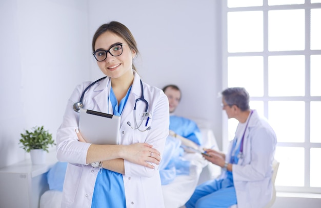 Female doctor using tablet computer in hospital lobby