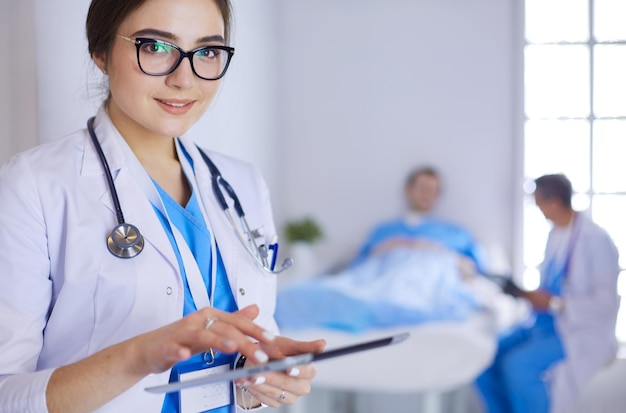 Female doctor using tablet computer in hospital lobby