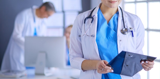 Female doctor using tablet computer in hospital lobby