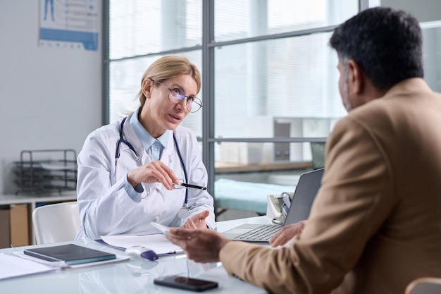 Female doctor wearing glasses and talking