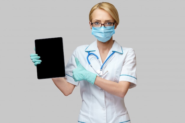 Female doctor wearing protective mask and gloves 