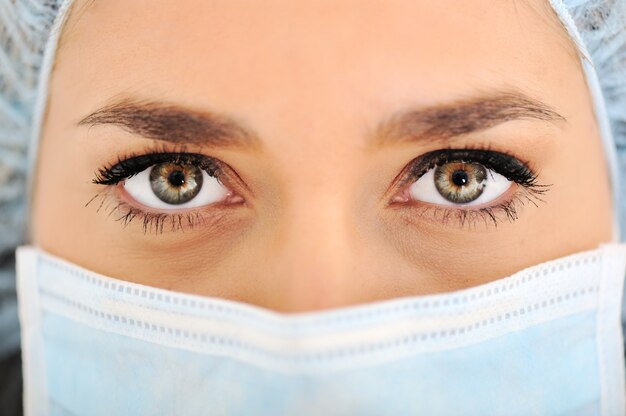 Female doctor wearing surgical cap and mask