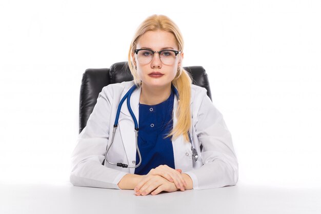 Female doctor in white coat at the table