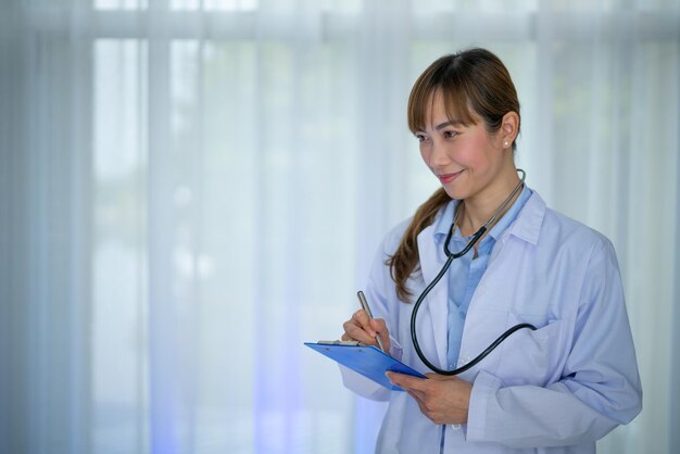 female doctor in white coat with Medical stethoscope Portrait beautiful young Asian doctor