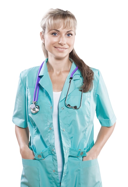 Female doctor with crossed arms holding hands in pockets looking at camera smiling isolated