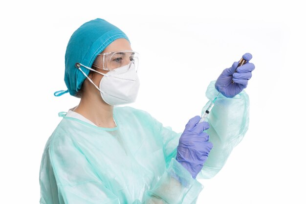 Female doctor with gloves and mask preparing injection