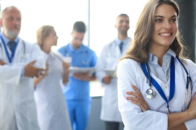 Female doctor with group of happy successful colleagues.