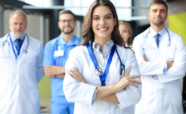 Female doctor with group of happy successful colleagues.